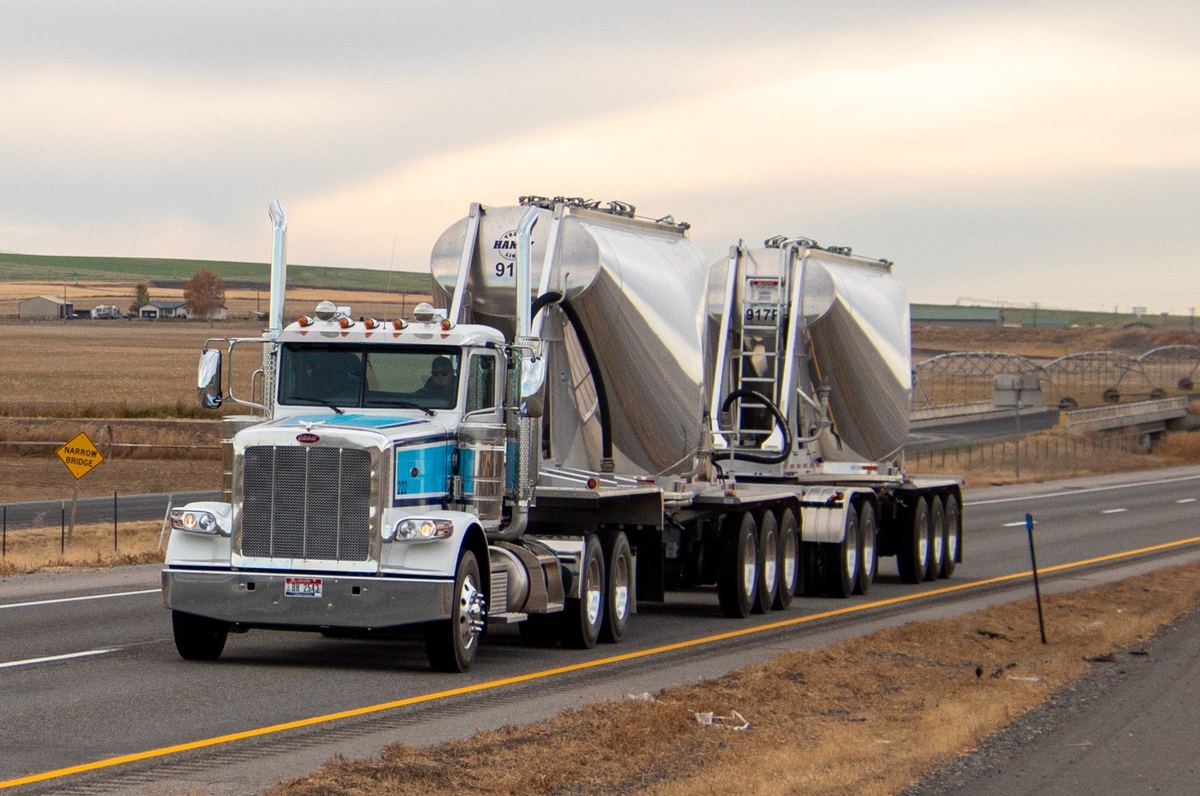 Pneumatic dry bulk trailers hauling commodities on the highway