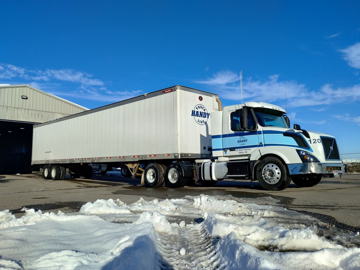 Handy Truck Line dry van tractor trailer under blue skies